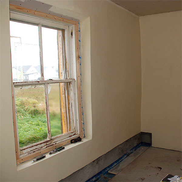 internal view of the building as refurbishment nears completion. The roof and floor have been insulated but the walls have been stripped back and plastered on the hard using lime in preference to internal insulation lining. We have taken great care though to ensure excellent airtightness as can be seen by the 'Contega' joint tape shown around the window, and the floor / wall junction